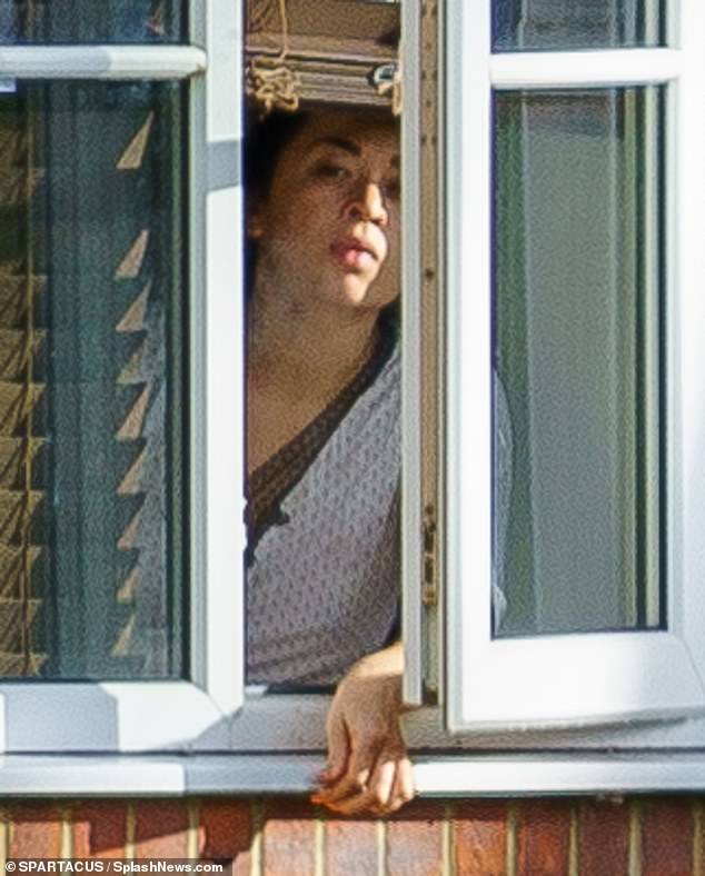 Isolating: Katya Jones puffed on a cigarette at her home in London as she self-isolates after testing positive for COVID-19