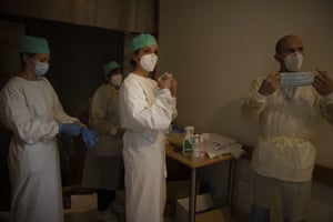 Army healthcare workers suit up before doing their rounds in the Covid-19 ward of a nursing home in Landenne, Belgium